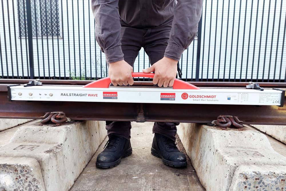 Kennards Hire team member using a spirit level