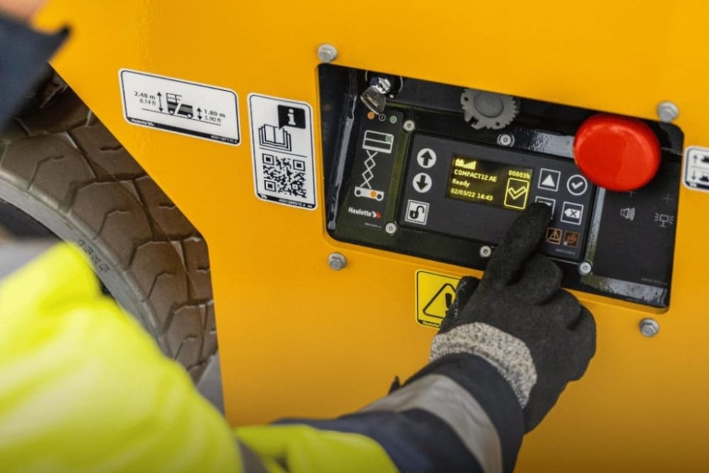 Kennards hire team member handling aerial work platforms from ground control