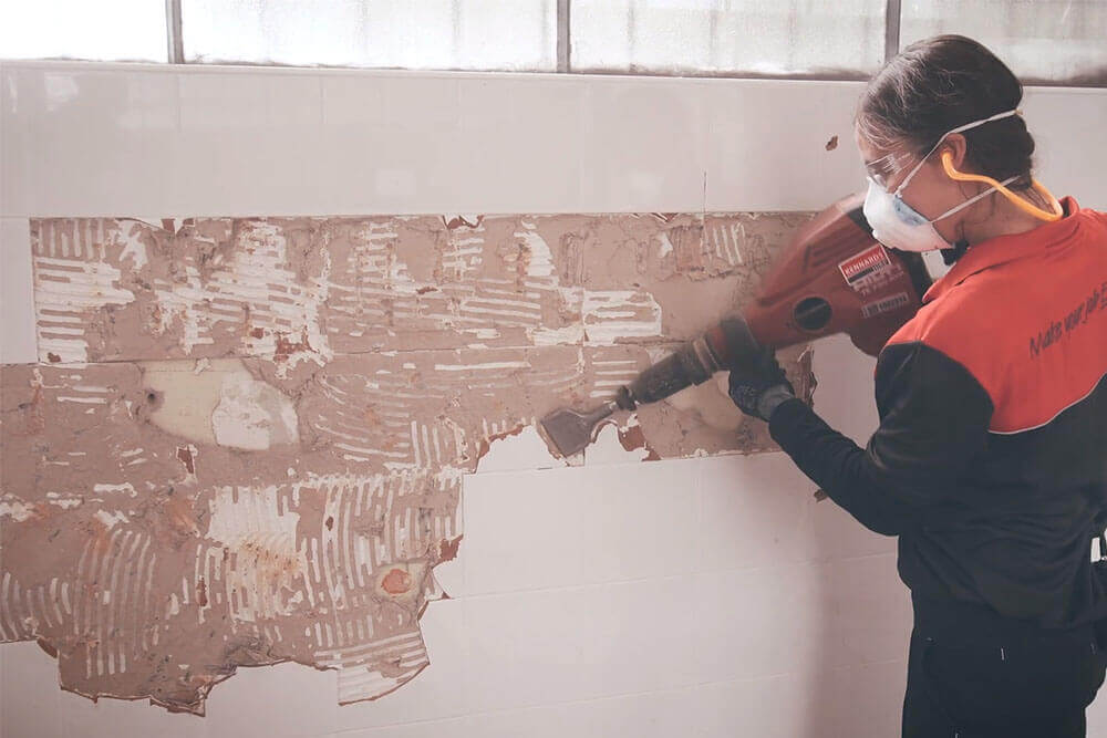 Kennards Hire team member operating a demolition hammer