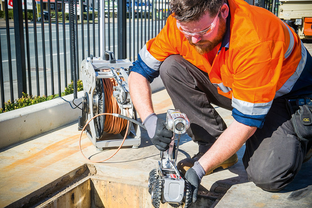 Kennards Hire team member using a camera robot