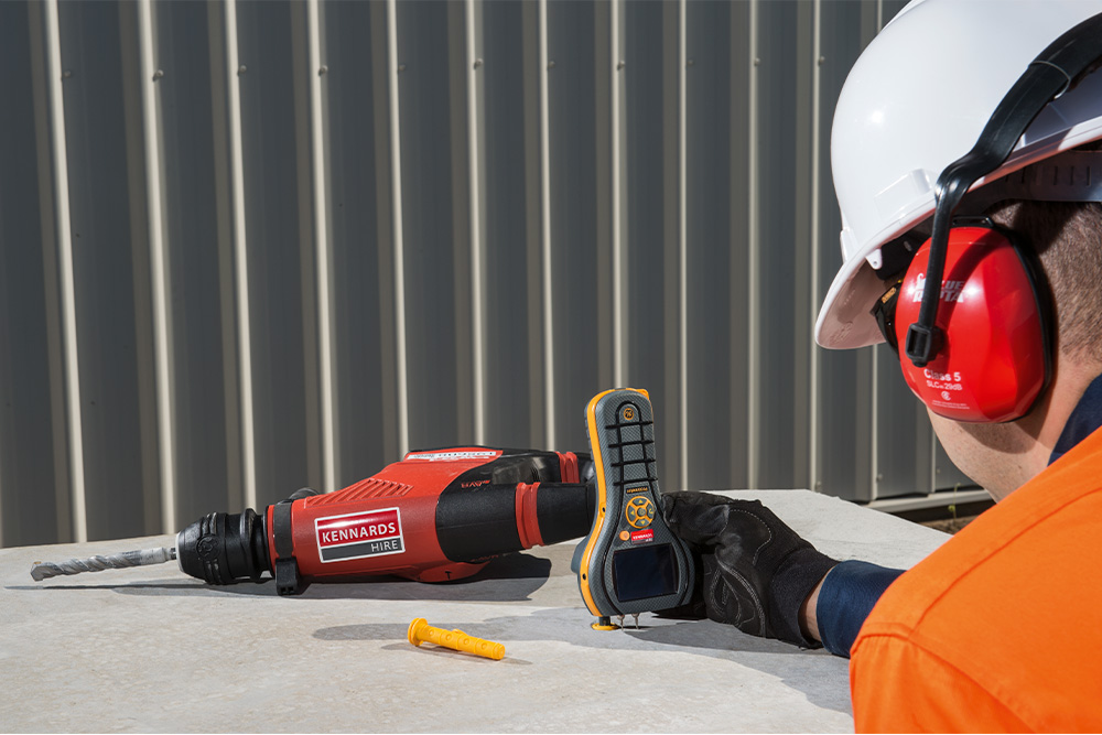 kennards hire team member using a moisture measuring tool
