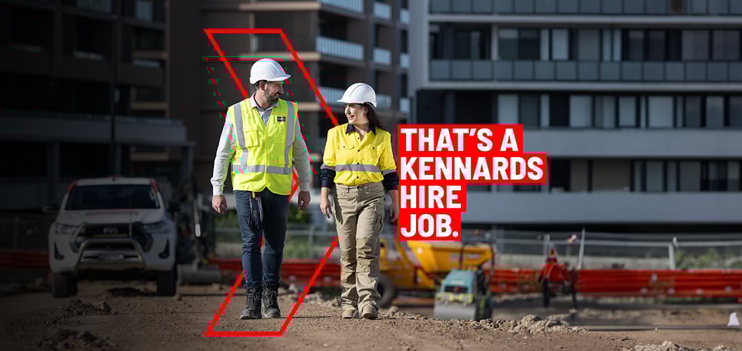 Kennards Hire team members walking on a job site discussing speciialist service solutions 