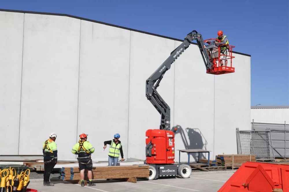 Kennards Hire team members operating a hydraulic platform outdoors